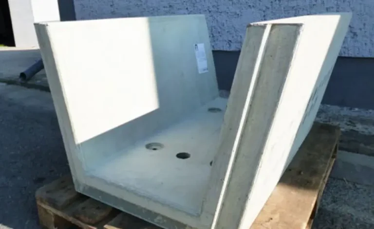 Betonschale mit zwei Öffnungen auf einer Holzpalette, in neutraler Umgebung.